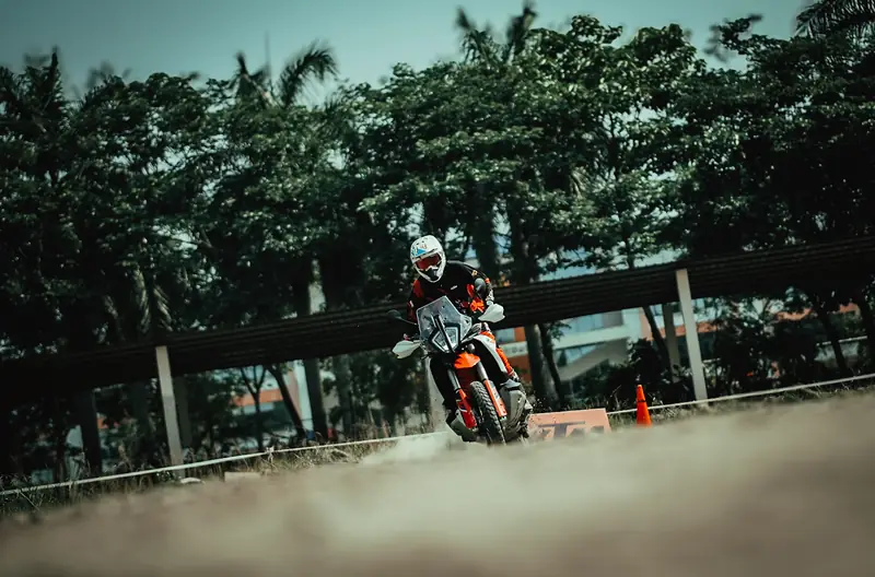 Rider on a tree-lined dirt track